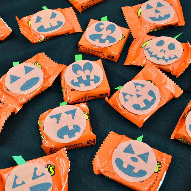 A group of Easy Halloween Treats Printable jack o lantern candy wrappers for Halloween treats from the Organized 31 Shop.