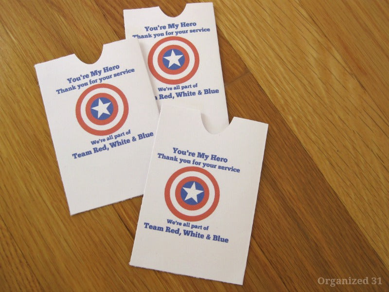 Three Thank Our Veterans gift tags on a wooden table.